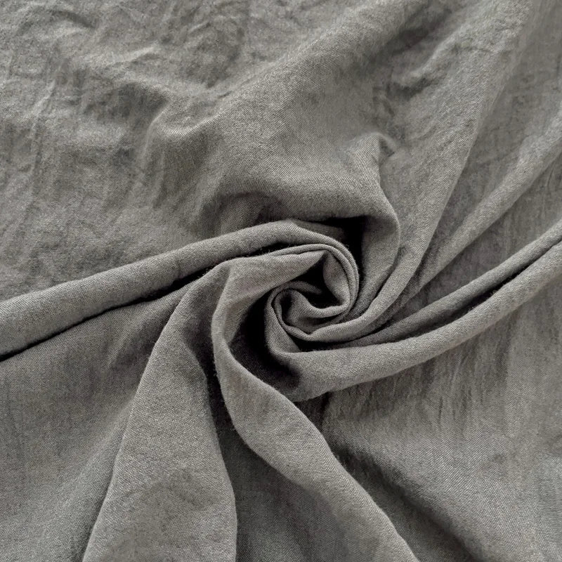 Set of two ultra-soft cotton-blend pillowcases in a minimalist solid colour, styled on a neutral-toned bed for a relaxed, cosy look.