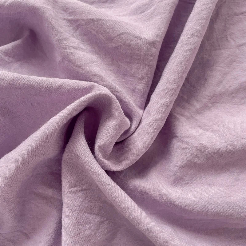 Set of two ultra-soft cotton-blend pillowcases in a minimalist solid colour, styled on a neutral-toned bed for a relaxed, cosy look.