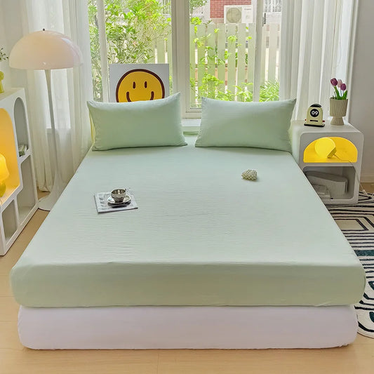 Solid-colour fitted sheet in polyester-cotton blend with soft knit texture, shown neatly on a bed with 28cm deep fit—available in Single, King Single, Queen, and King sizes.