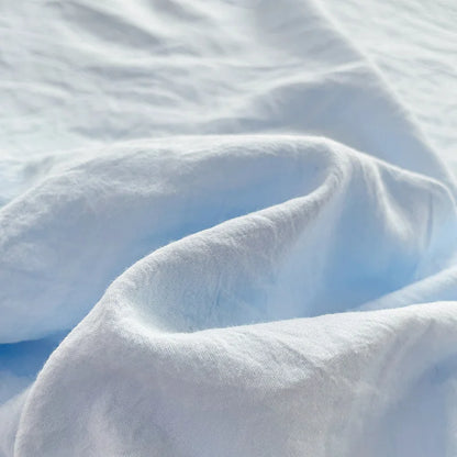 Set of two ultra-soft cotton-blend pillowcases in a minimalist solid colour, styled on a neutral-toned bed for a relaxed, cosy look.