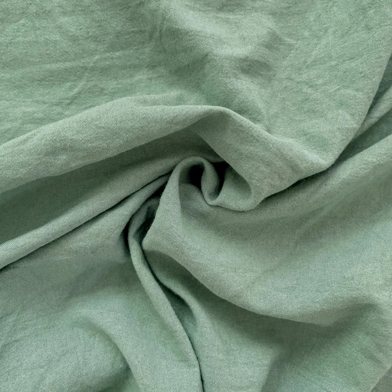 Set of two ultra-soft cotton-blend pillowcases in a minimalist solid colour, styled on a neutral-toned bed for a relaxed, cosy look.