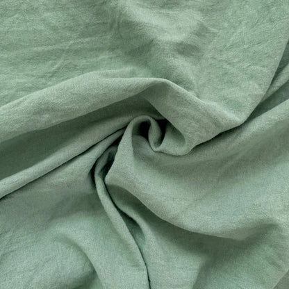 Set of two ultra-soft cotton-blend pillowcases in a minimalist solid colour, styled on a neutral-toned bed for a relaxed, cosy look.