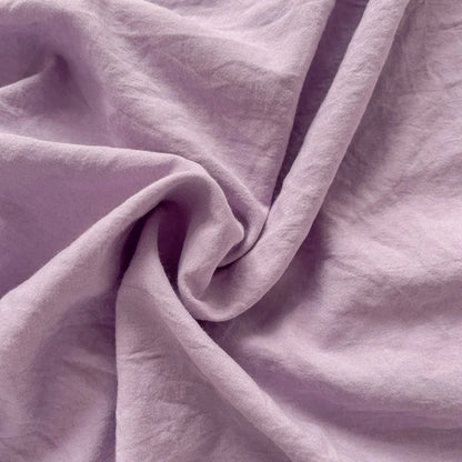 Set of two ultra-soft cotton-blend pillowcases in a minimalist solid colour, styled on a neutral-toned bed for a relaxed, cosy look.
